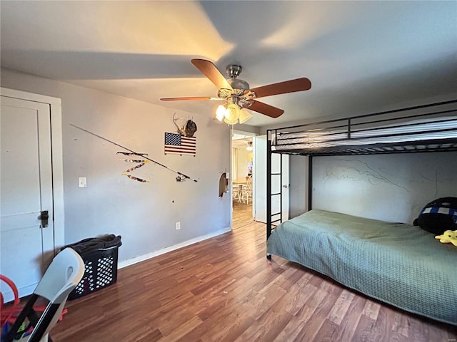 bedroom with ceiling fan and hardwood / wood-style floors