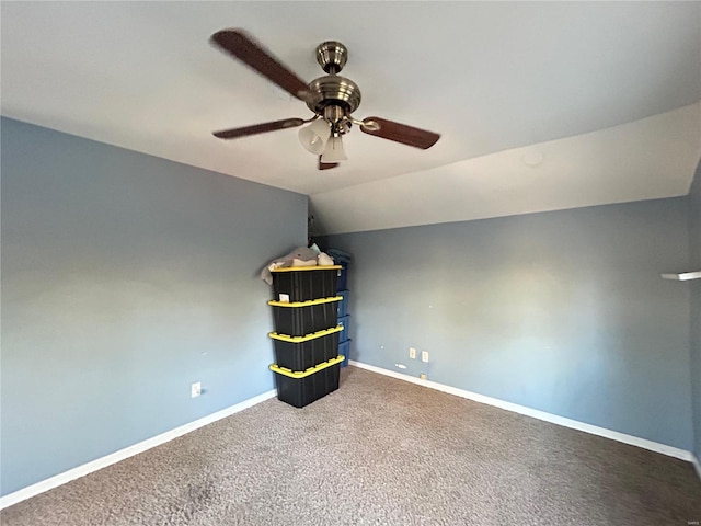 interior space featuring ceiling fan, carpet, and lofted ceiling