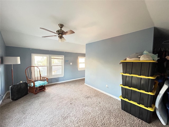 sitting room featuring carpet floors, vaulted ceiling, and ceiling fan