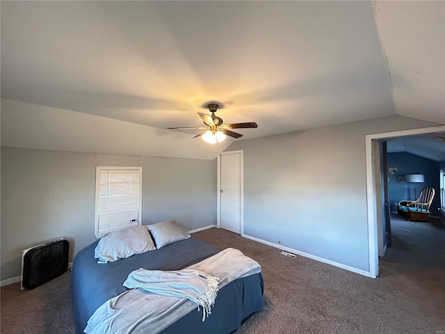 carpeted bedroom with ceiling fan and vaulted ceiling