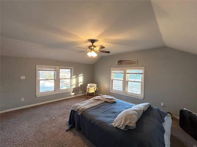 carpeted bedroom with multiple windows, vaulted ceiling, and ceiling fan