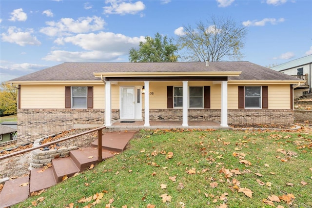 ranch-style home featuring a porch and a front yard