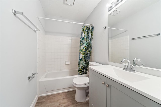 full bathroom with hardwood / wood-style floors, vanity, toilet, and shower / bath combo with shower curtain