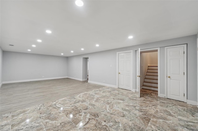 basement with light hardwood / wood-style floors