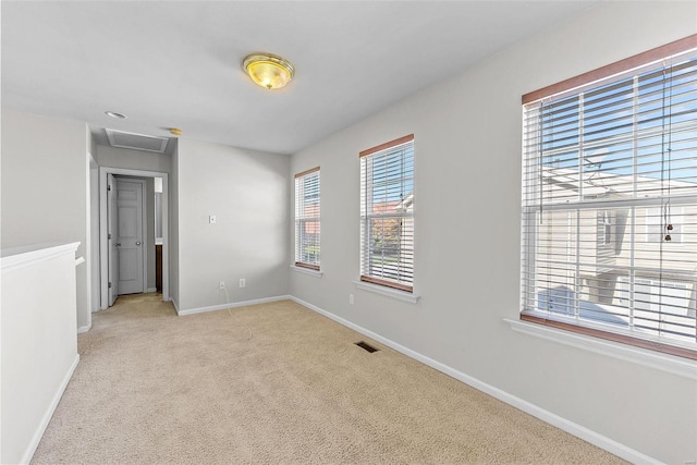 carpeted empty room with a wealth of natural light