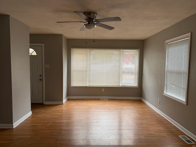 unfurnished room featuring light wood-type flooring and ceiling fan