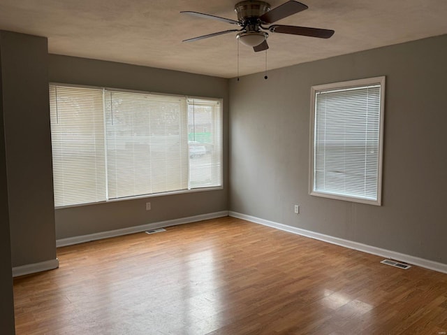 unfurnished room featuring ceiling fan and light wood-type flooring