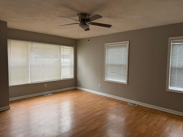 spare room featuring ceiling fan and light hardwood / wood-style flooring