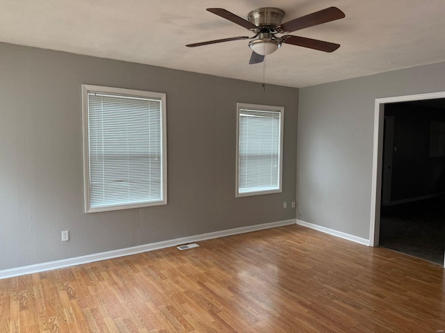 spare room with ceiling fan and light hardwood / wood-style flooring