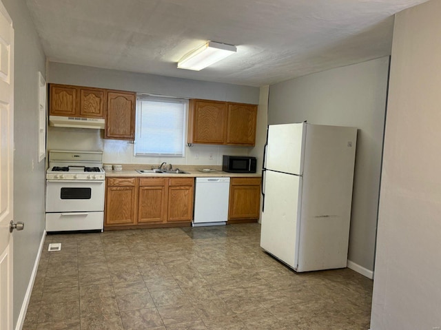 kitchen featuring white appliances and sink