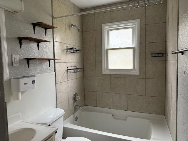 full bathroom with vanity, toilet, and tiled shower / bath