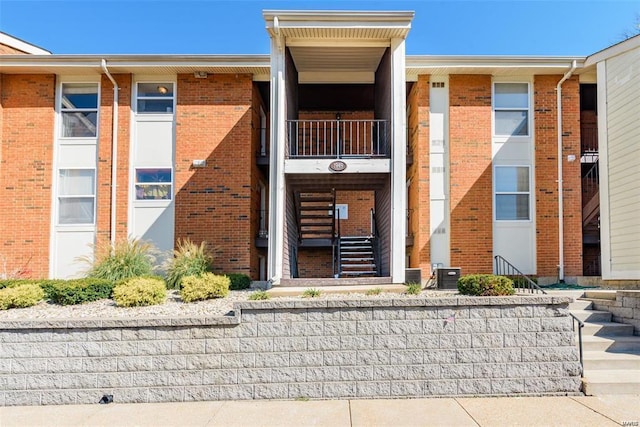 property entrance featuring central air condition unit and a balcony