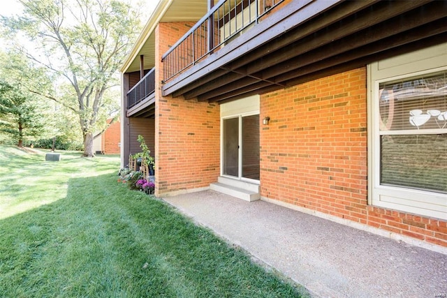 exterior space with a lawn and a balcony