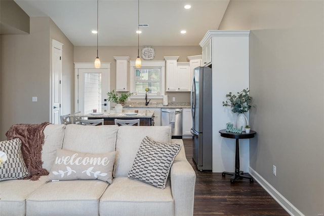 living room with dark hardwood / wood-style flooring and sink