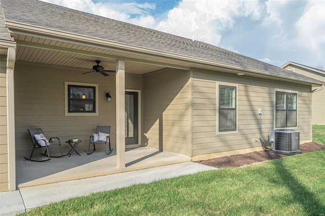 rear view of house featuring a lawn, ceiling fan, central AC, and a patio area