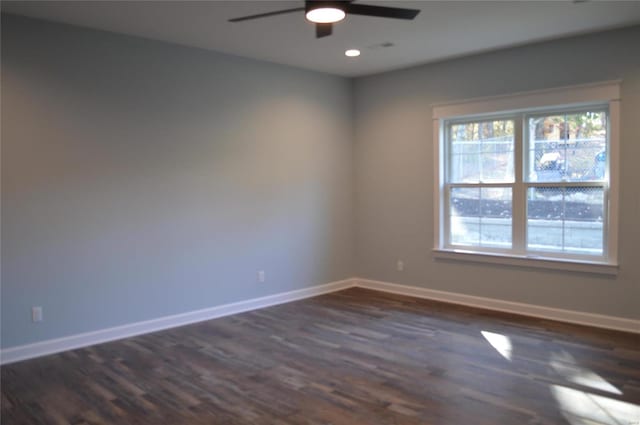 unfurnished room featuring dark wood-type flooring and ceiling fan