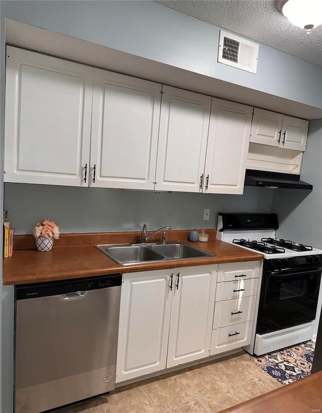 kitchen with white gas range, sink, white cabinets, and stainless steel dishwasher