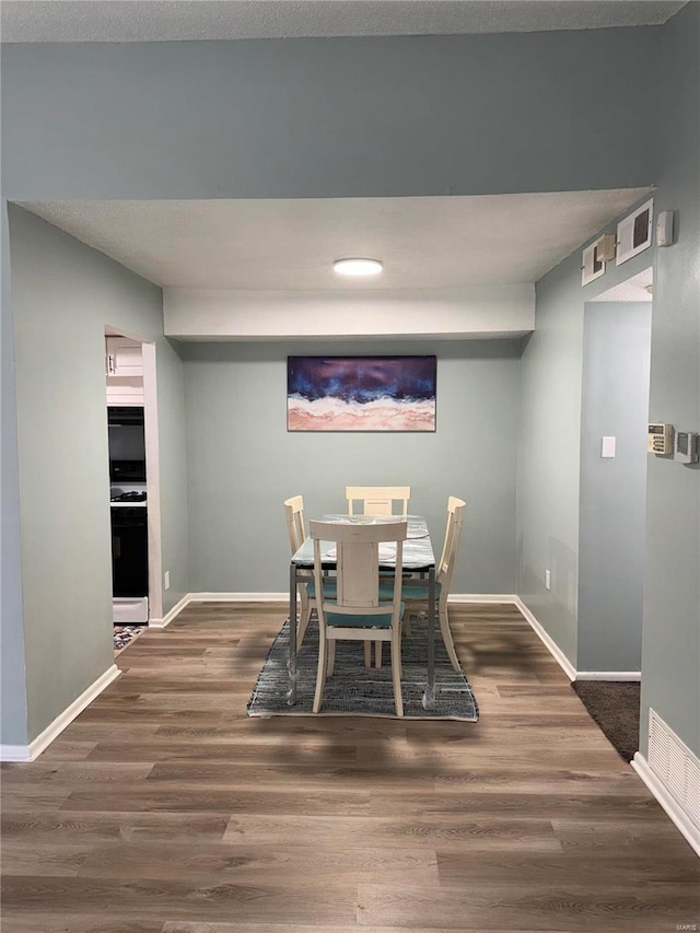 dining space featuring dark hardwood / wood-style flooring