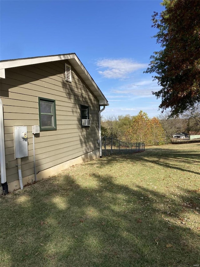 view of side of home with a yard and cooling unit