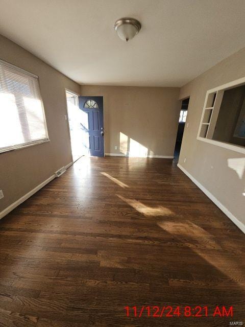 empty room with baseboards and wood finished floors