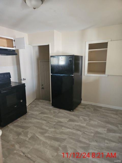 kitchen with under cabinet range hood and black appliances