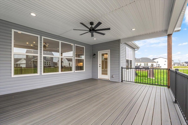 deck featuring a yard, a residential view, and ceiling fan