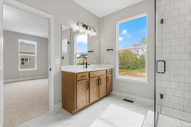 bathroom featuring marble finish floor, baseboards, and a stall shower