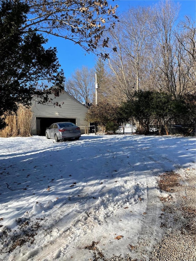 snowy yard featuring a garage