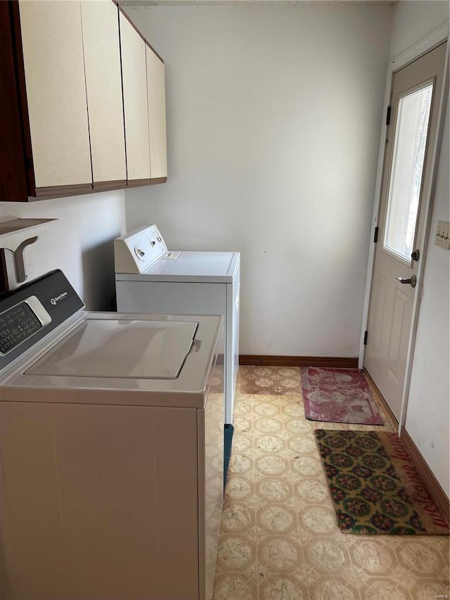 laundry room featuring cabinets and washing machine and clothes dryer