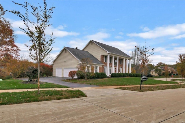 view of front of property featuring a garage and a front yard