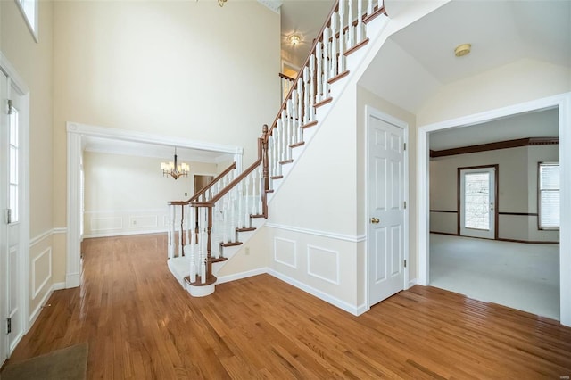 foyer with hardwood / wood-style floors and a notable chandelier