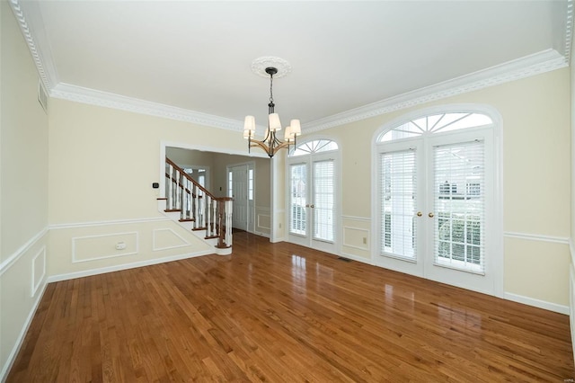 interior space featuring french doors, crown molding, and dark wood-type flooring