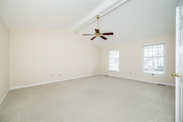 carpeted spare room with ceiling fan and lofted ceiling with beams