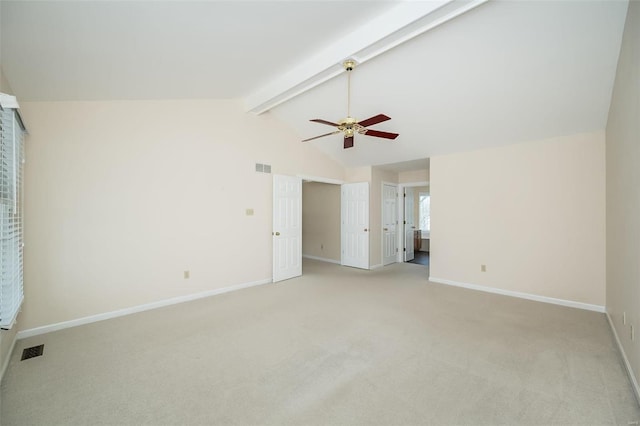 carpeted spare room featuring ceiling fan and lofted ceiling with beams