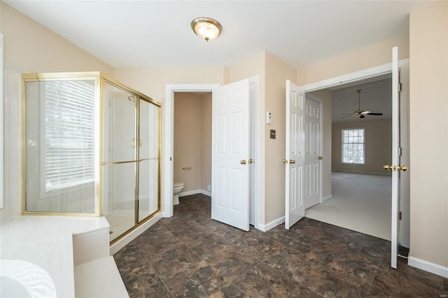 bathroom with toilet and a shower with door