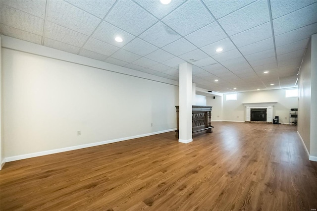 interior space with wood-type flooring and a drop ceiling