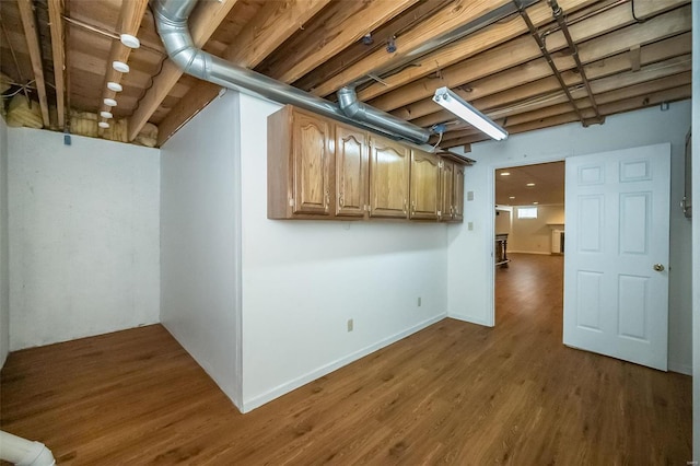 basement with dark hardwood / wood-style floors