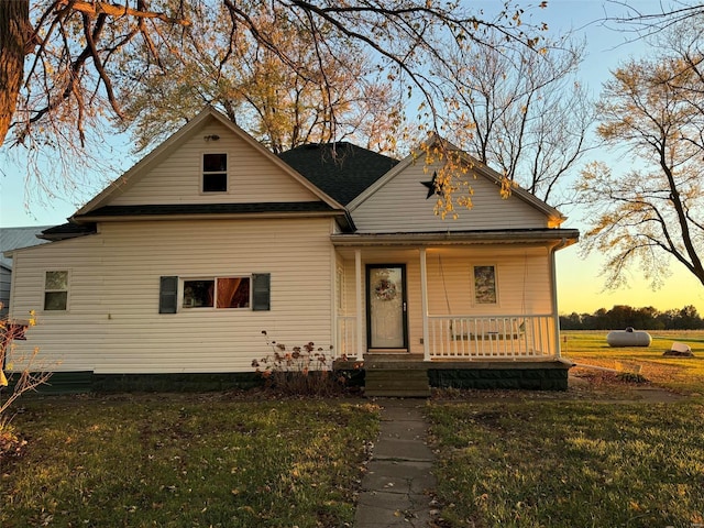 view of front facade with a yard and covered porch