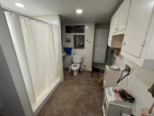 bathroom with a shower with shower curtain, toilet, and tile walls