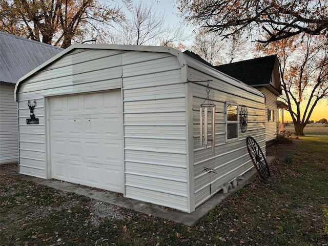 view of garage at dusk