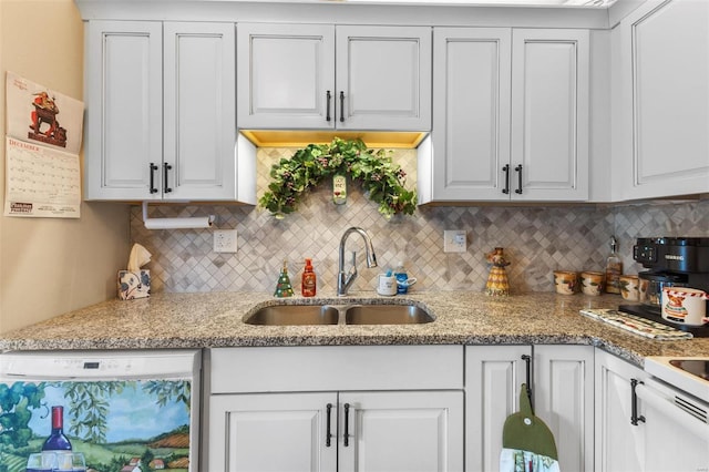 kitchen featuring dishwasher, white cabinetry, and sink