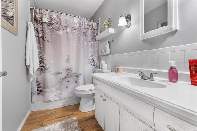 full bathroom with wood-type flooring, vanity, shower / tub combo, and toilet