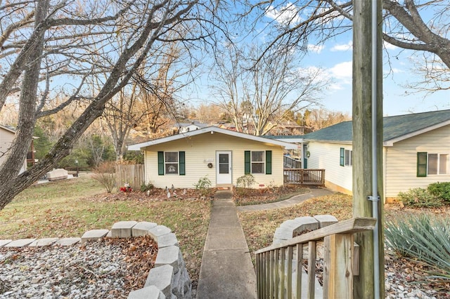 single story home featuring a wooden deck