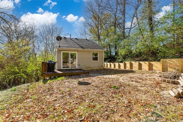 back of property with a wooden deck