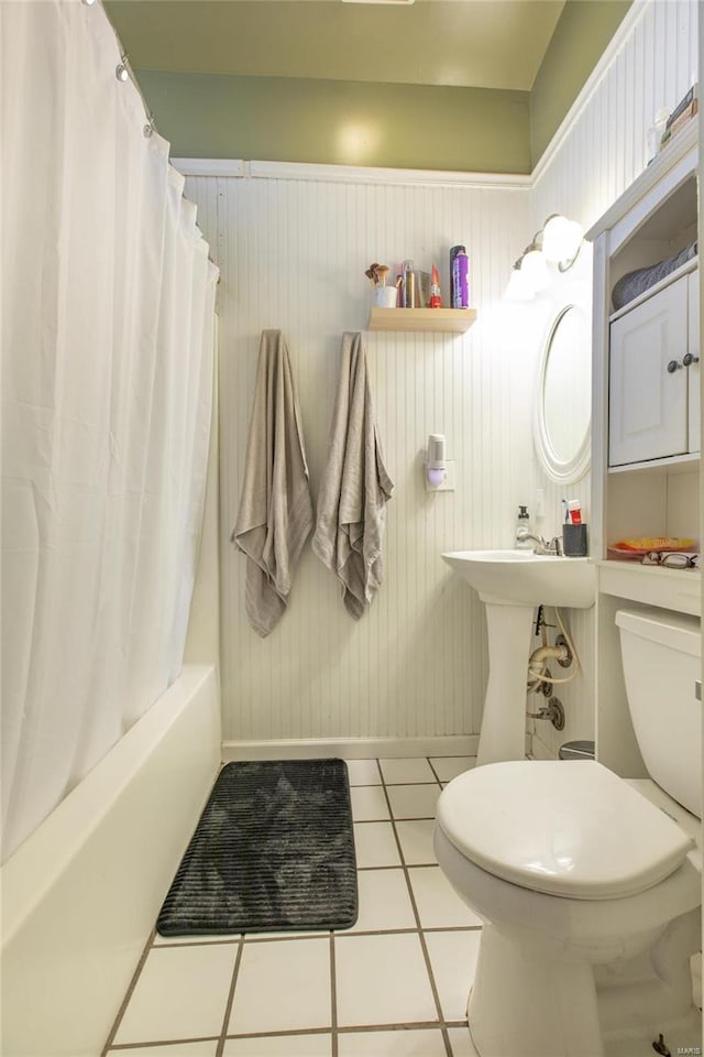 bathroom featuring shower / tub combo with curtain, tile patterned floors, toilet, and wooden walls