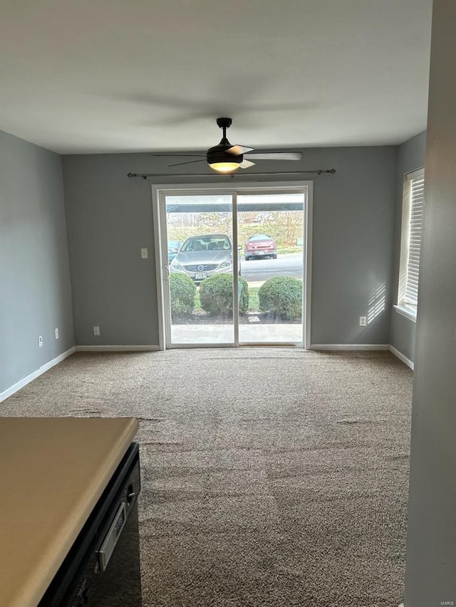 carpeted empty room featuring ceiling fan