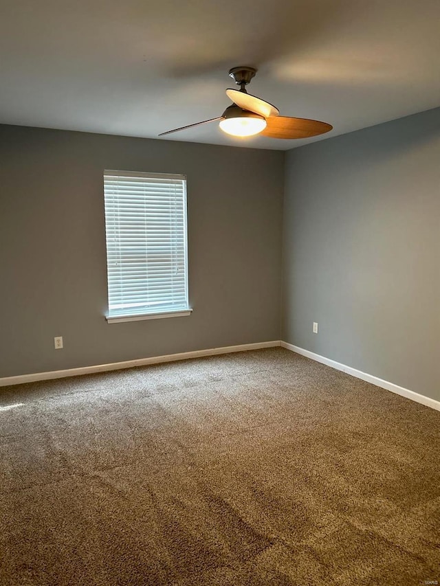 carpeted spare room with ceiling fan