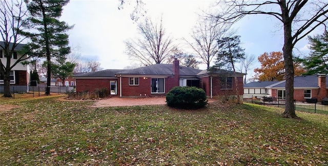 back of property featuring a patio area and a yard