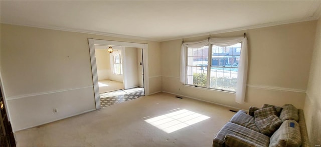 unfurnished living room featuring carpet and crown molding