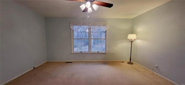 spare room featuring ceiling fan and carpet floors